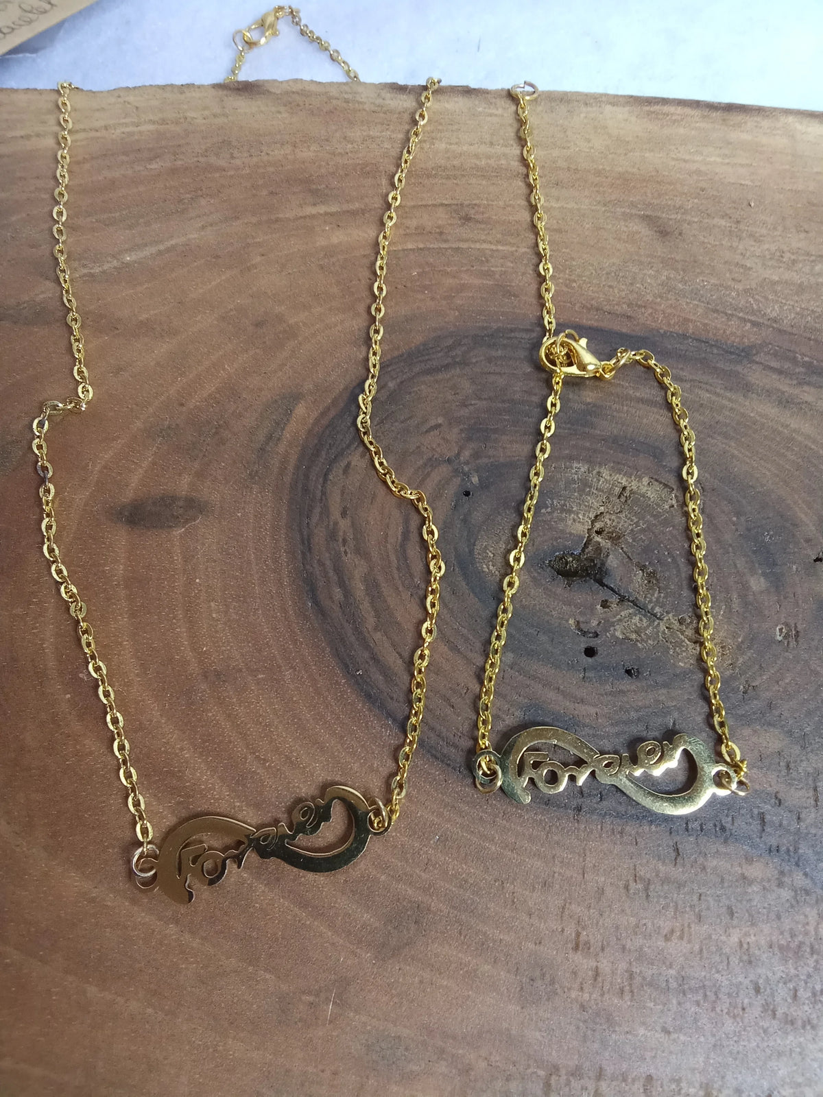 Parure Forever dorée - collier et bracelet en acier inoxydable avec pendentif infini