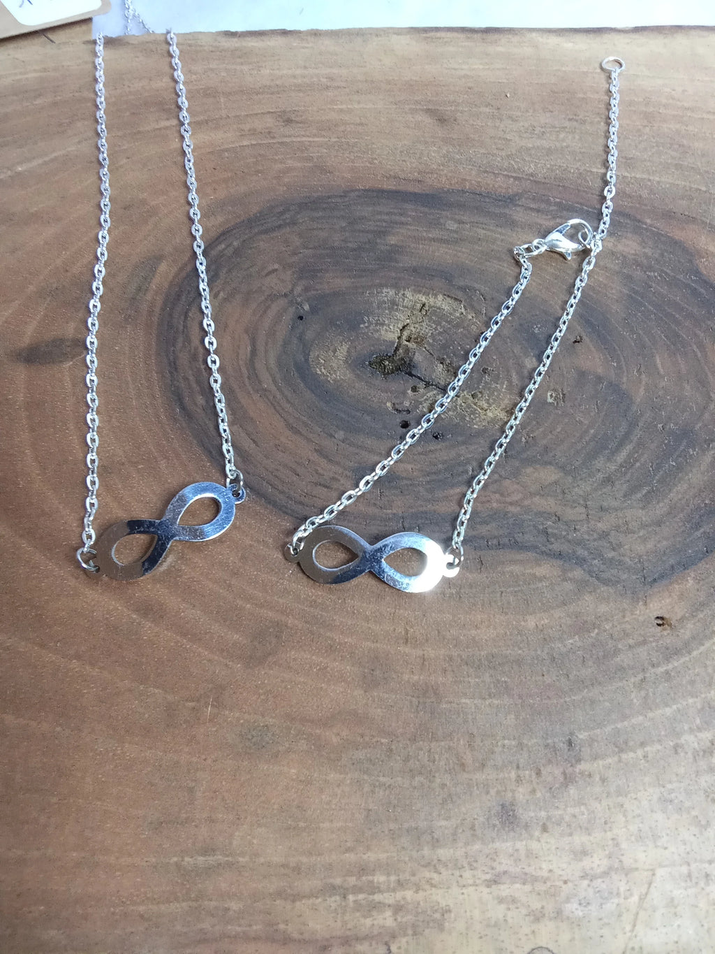 Parure infini argentée - collier et bracelet en acier inoxydable avec pendentif infini