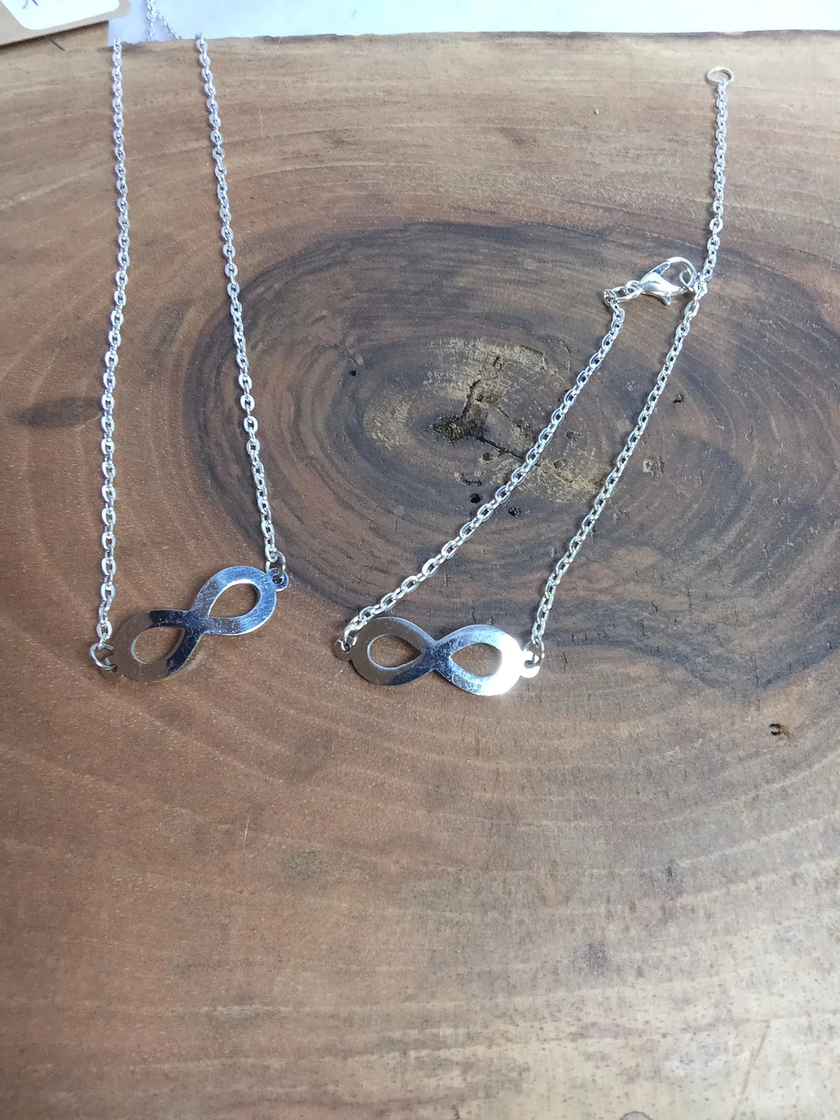 Parure infini argentée - collier et bracelet en acier inoxydable avec pendentif infini